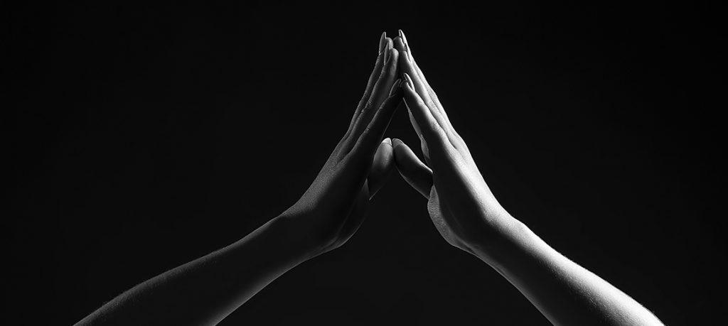 hands praying in black and white
